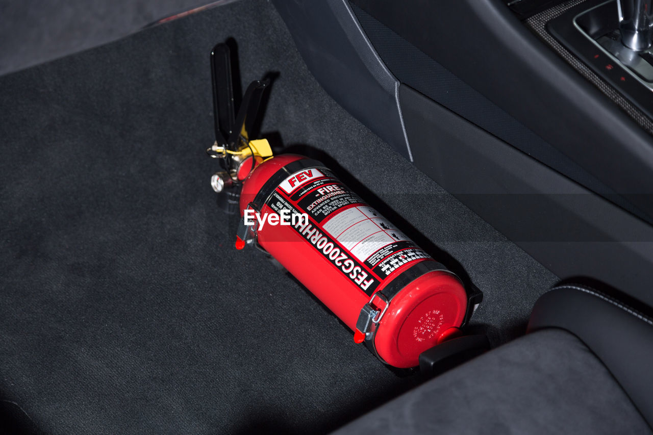 HIGH ANGLE VIEW OF RED VINTAGE CAR ON FLOOR