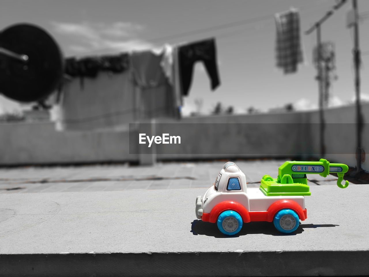 CLOSE-UP OF TOY CAR ON CITY STREET