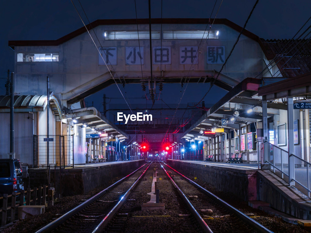 rail transportation, transportation, railroad track, track, train station, architecture, metropolitan area, mode of transportation, transport, public transportation, train, built structure, railroad station, illuminated, public transport, vehicle, night, travel, city, railroad station platform, no people, outdoors, building exterior, railway, travel destinations, urban area, metro, nature
