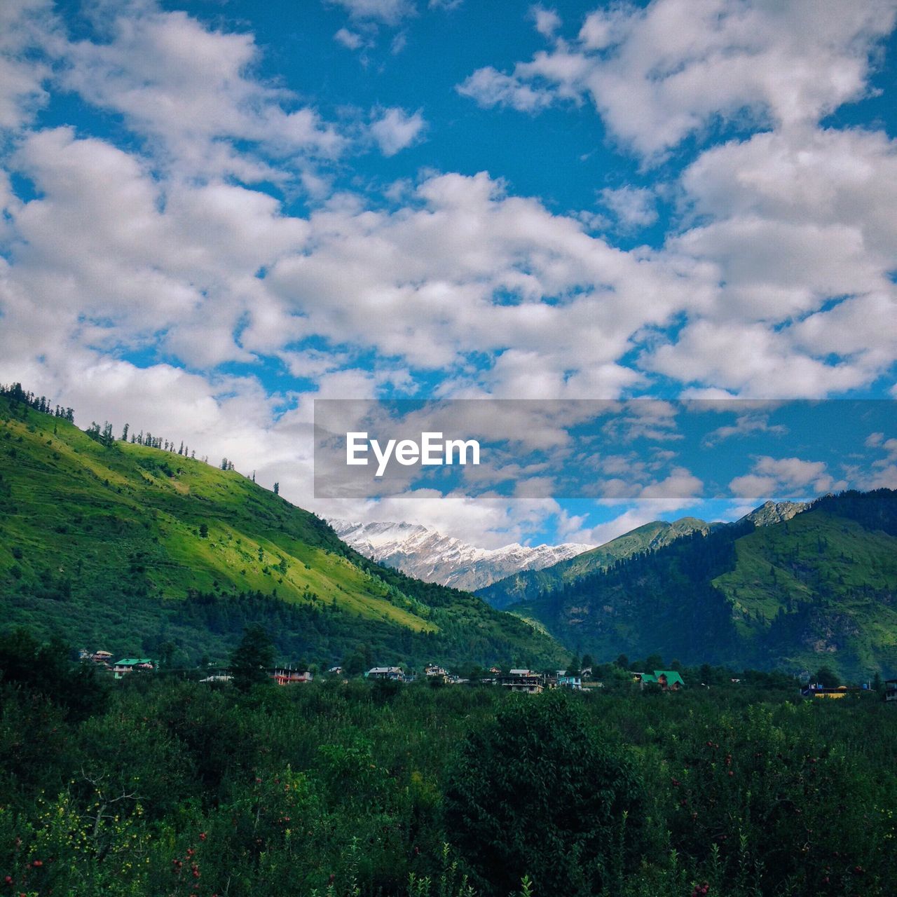 SCENIC VIEW OF MOUNTAINS AGAINST CLOUDY SKY