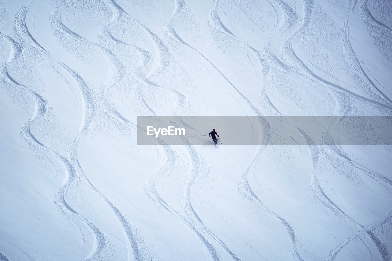 Person skiing on snow covered mountain