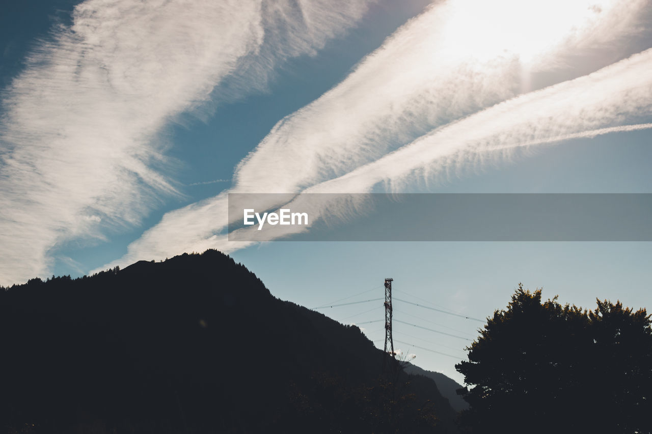 LOW ANGLE VIEW OF ELECTRICITY PYLON AGAINST MOUNTAIN