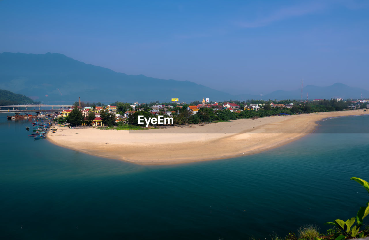 PANORAMIC VIEW OF SEA AND BUILDINGS AGAINST SKY