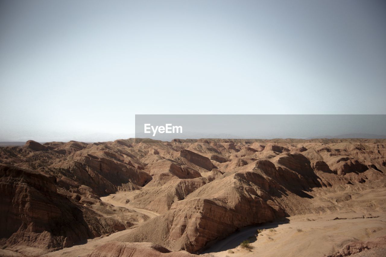 Scenic view of desert against clear sky