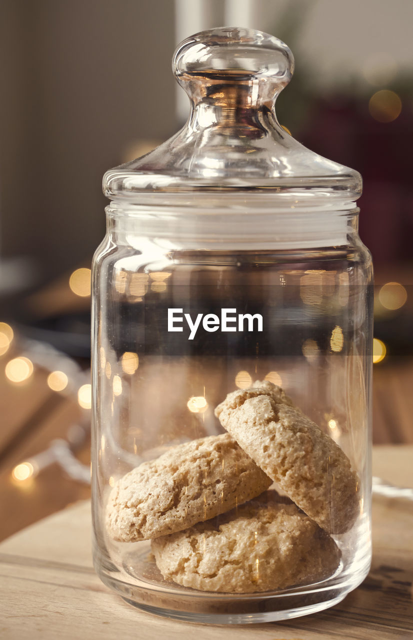 CLOSE-UP OF COOKIES IN JAR ON TABLE