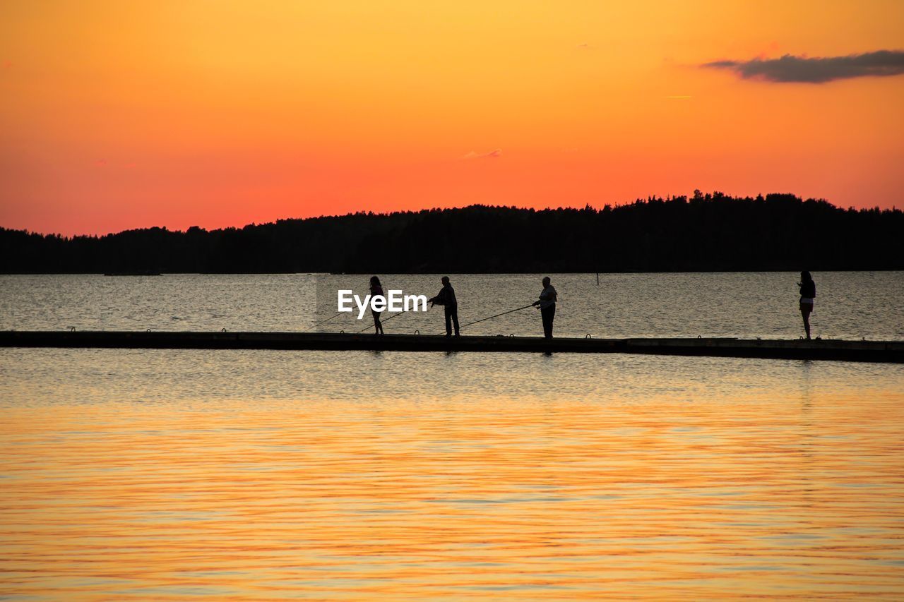 Silhouette of people at sunset