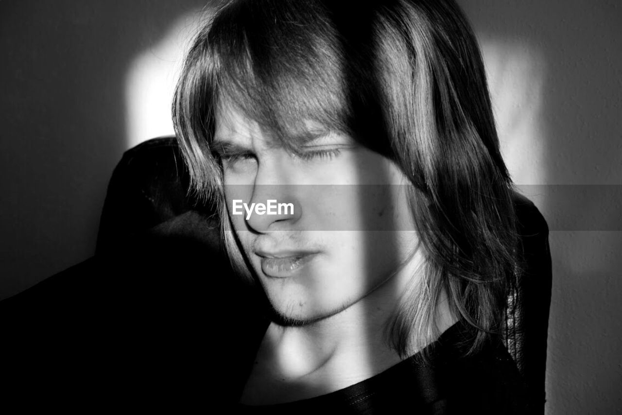 Close-up portrait of teenage boy at home