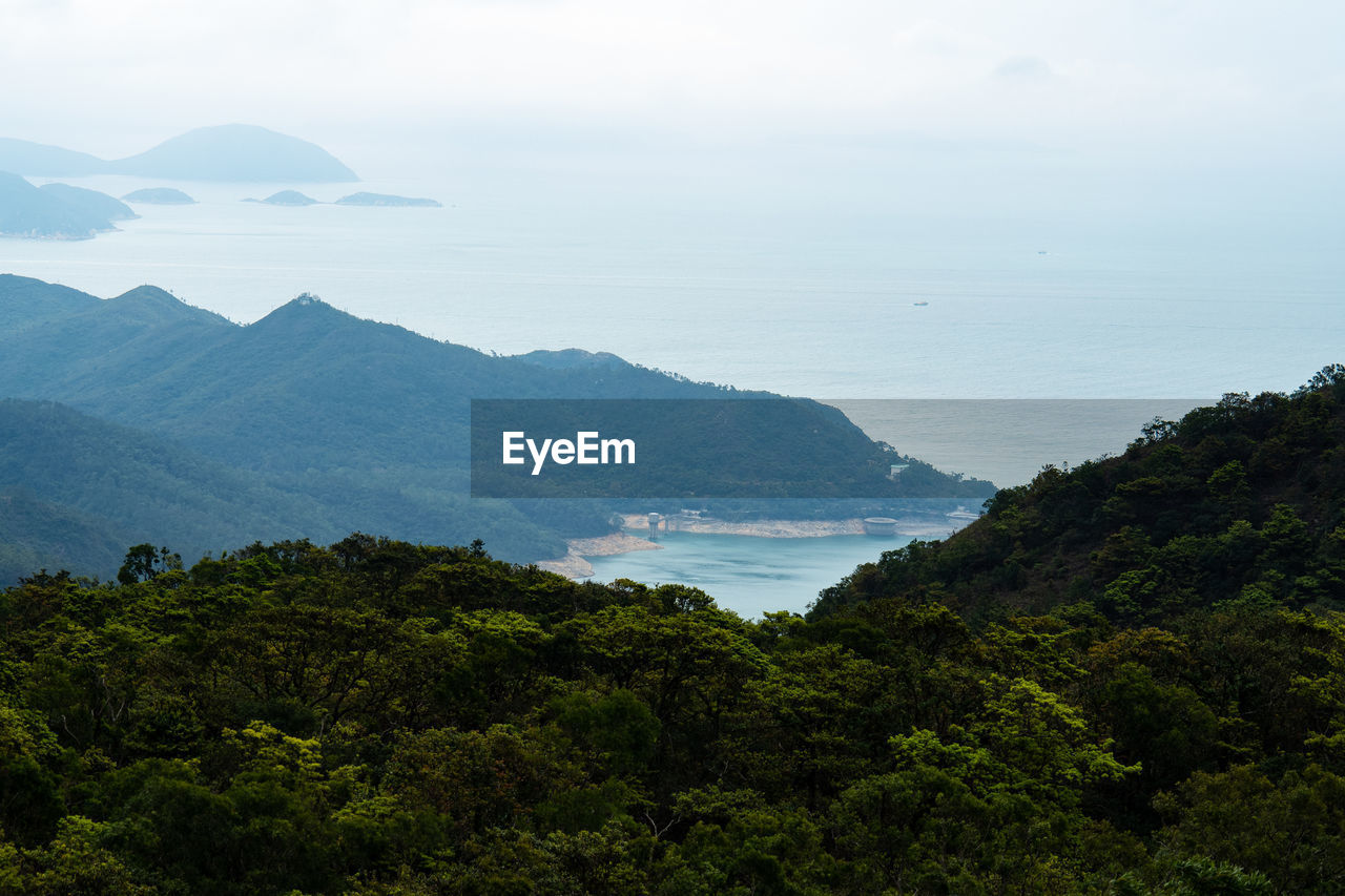 High angle view of sea and mountains against sky