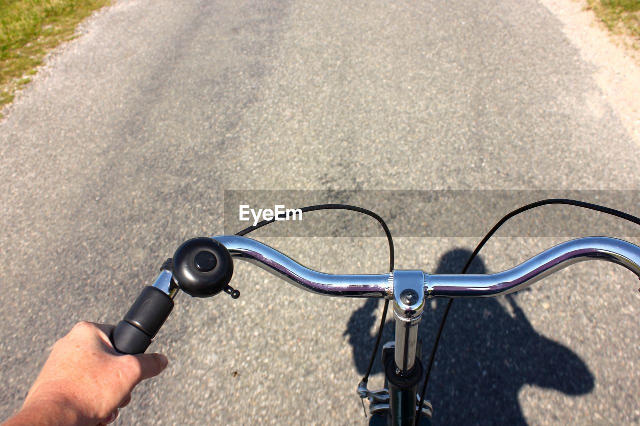 Close-up of person riding bicycle on road