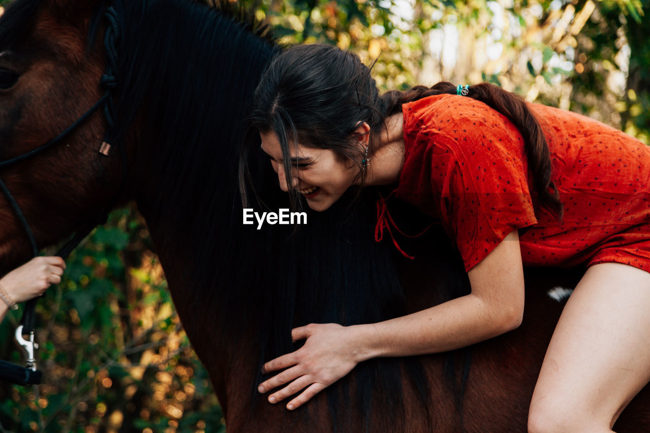 Portrait of woman sitting on horse