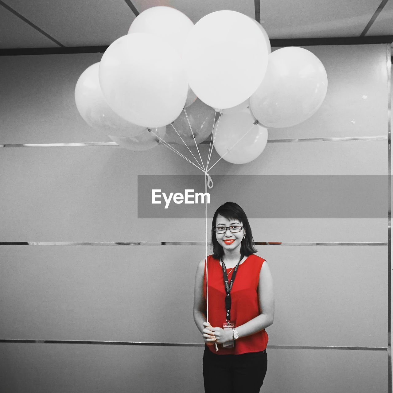 PORTRAIT OF WOMAN WITH BALLOON ON BALLOONS