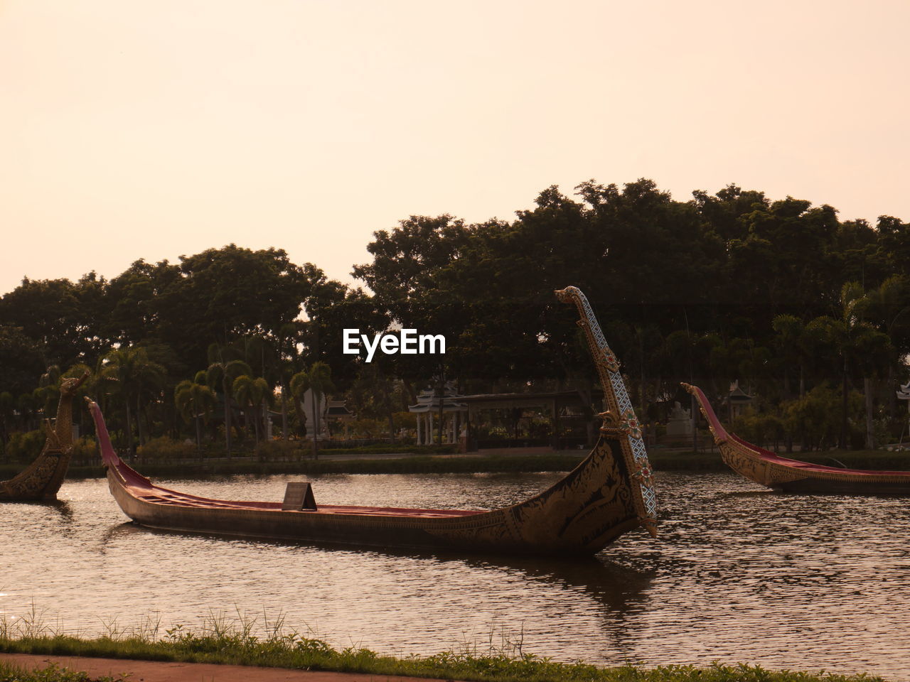 nautical vessel, water, transportation, boat, tree, nature, sea, vehicle, sky, mode of transportation, sunset, plant, long-tail boat, travel, canoe, tranquility, travel destinations, no people, land, outdoors, watercraft, shore, scenics - nature, beauty in nature, environment, beach, tranquil scene, landscape, evening, moored, tourism