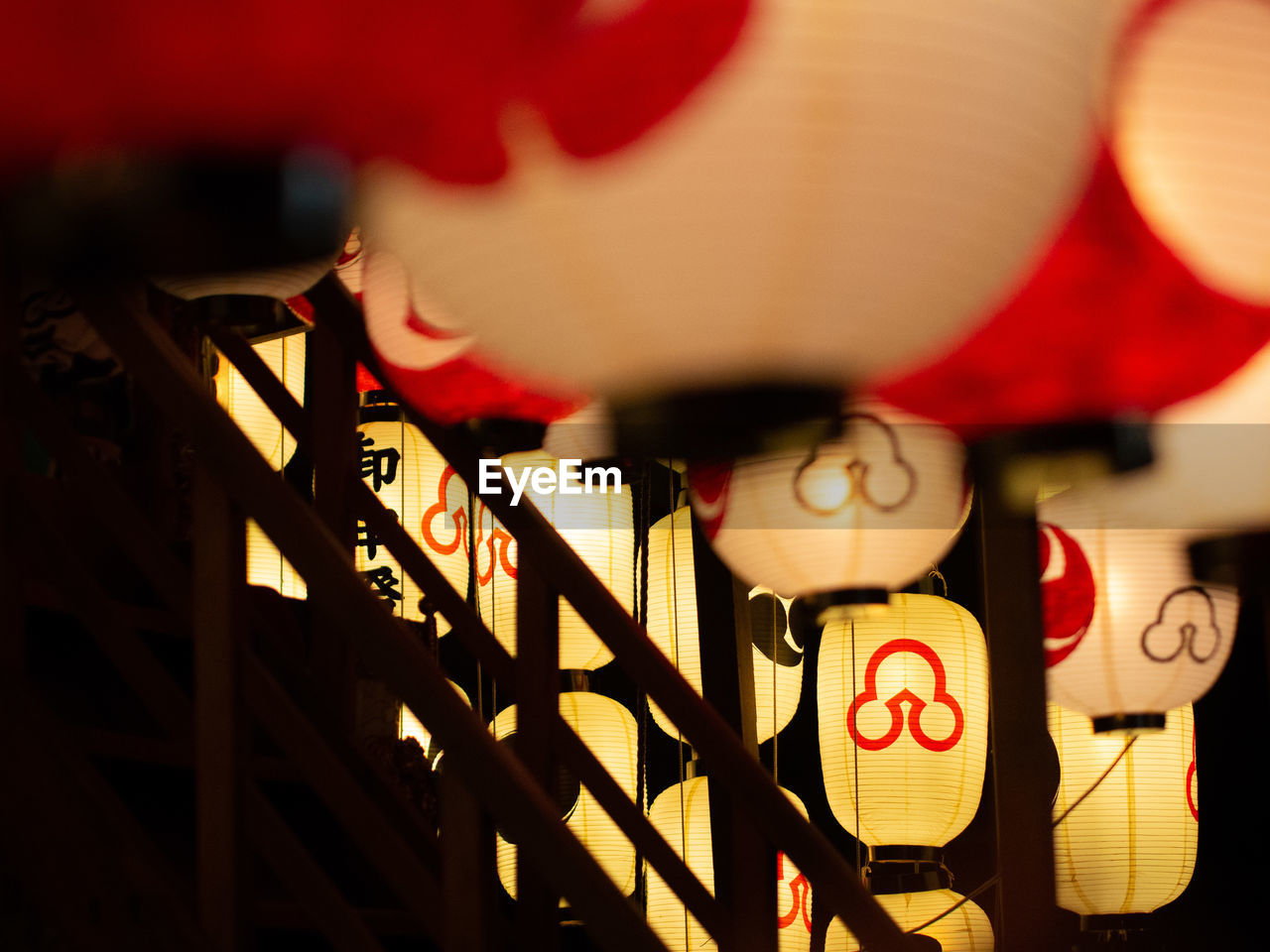 Illuminated lanterns hanging in darkroom