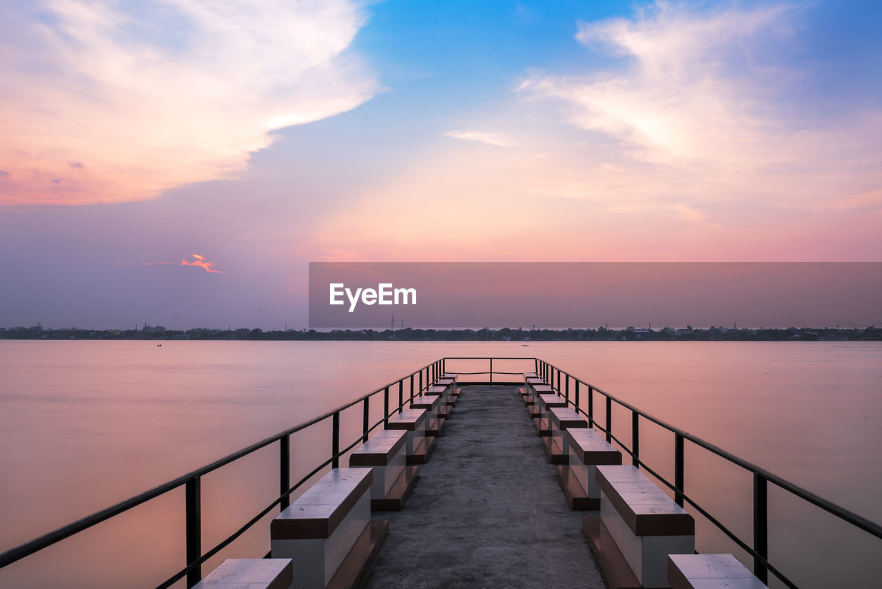 VIEW OF PIER ON SEA AGAINST SKY DURING SUNSET
