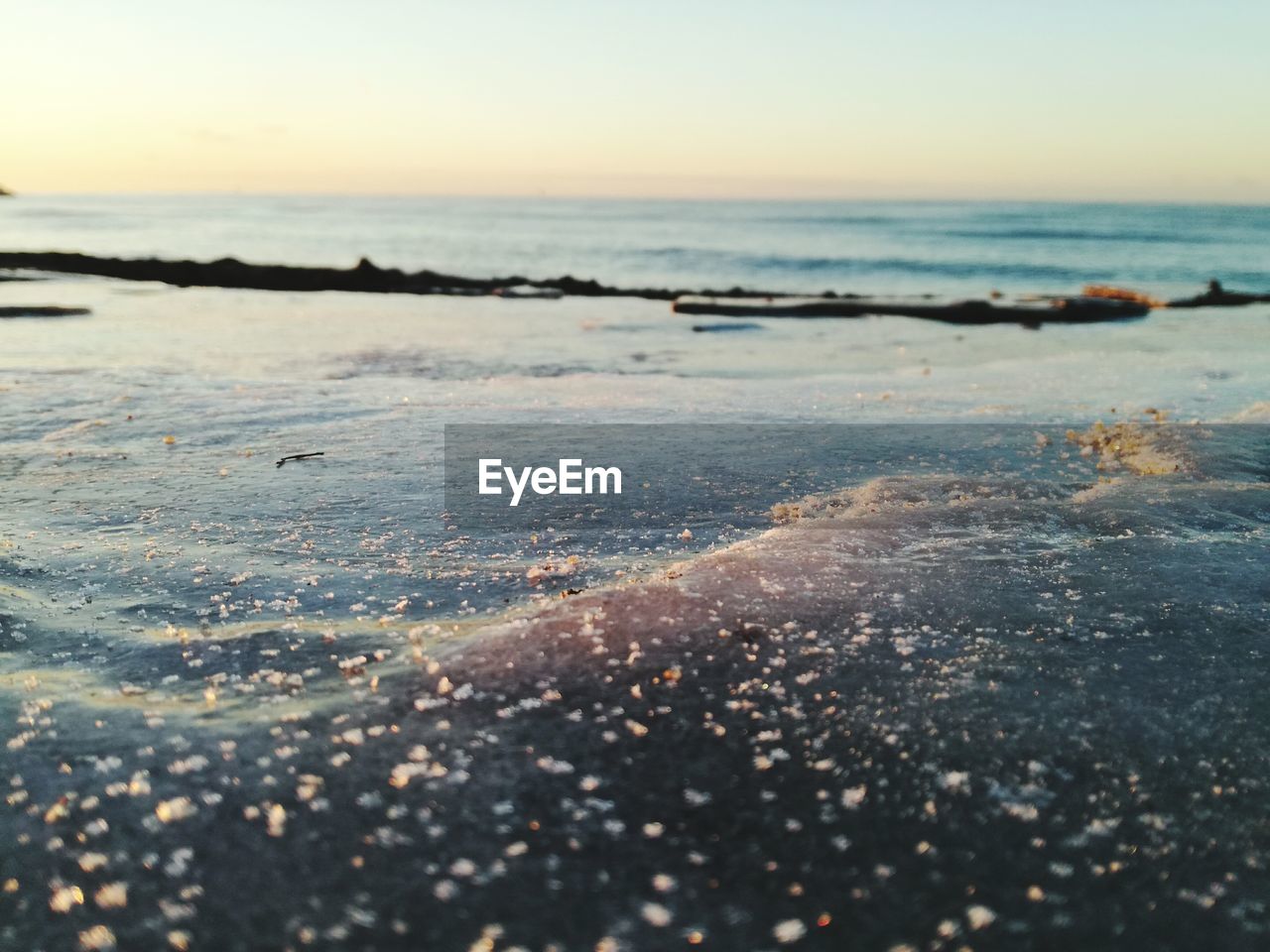 CLOSE-UP OF SEA SHORE AGAINST SKY