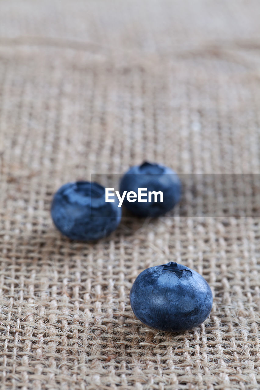 HIGH ANGLE VIEW OF FRUITS ON BLUE TABLE