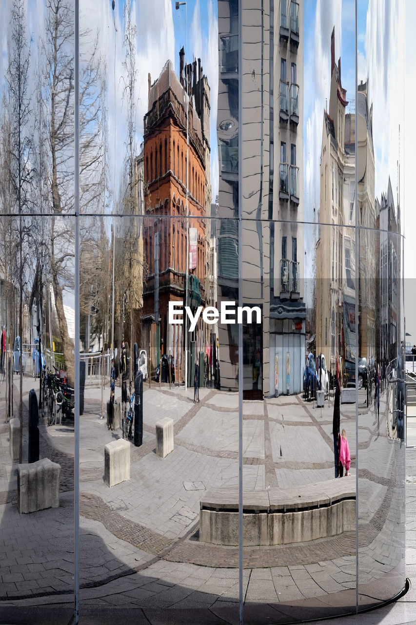 Reflection of buildings and street on glass