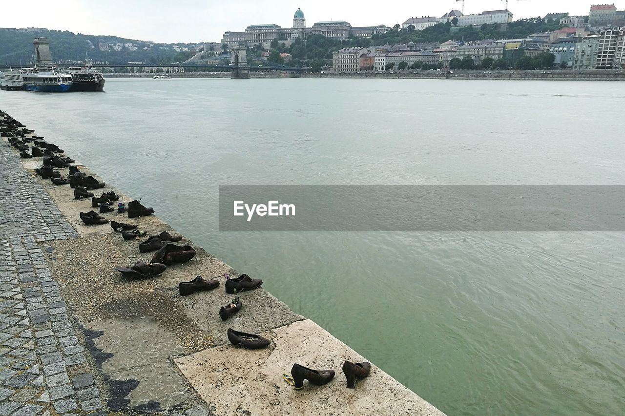 Shoes by danube river in city on sunny day