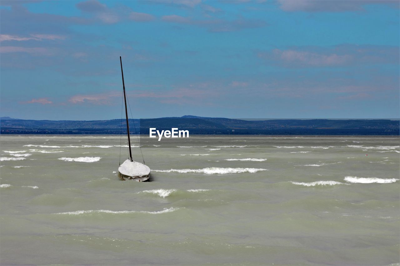 BOAT IN SEA AGAINST SKY