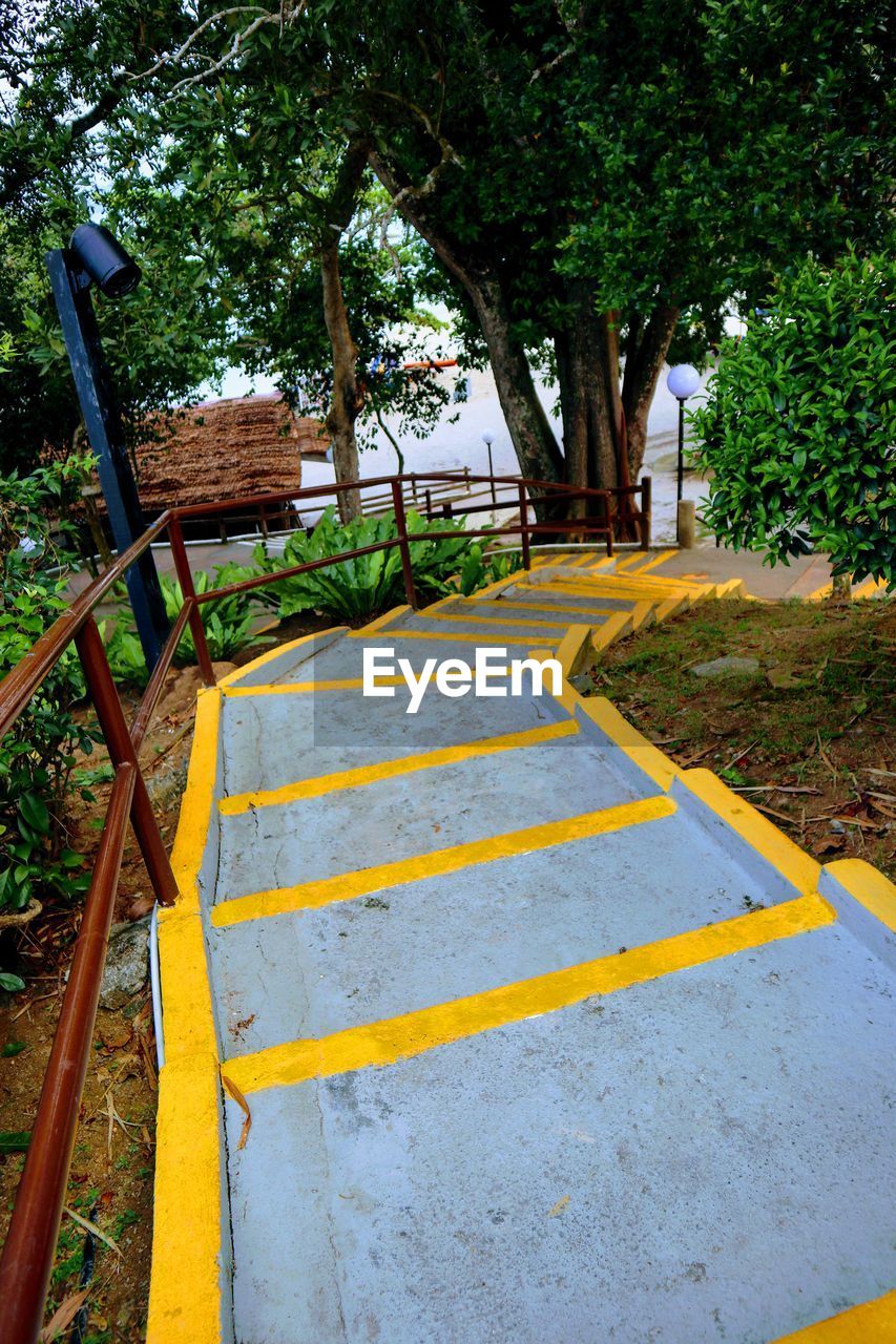 VIEW OF PARK BENCH BY RAILING