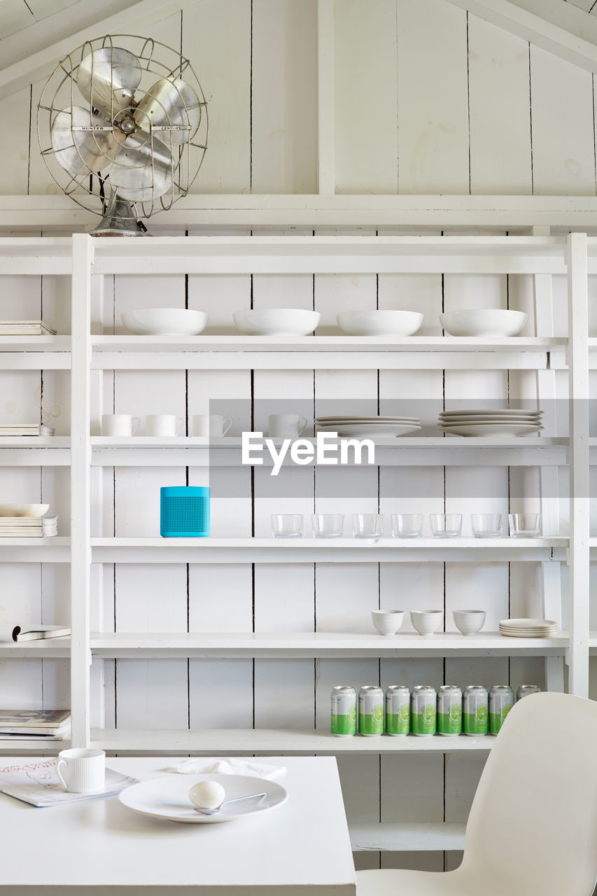 Organized shelving in clean, white shed