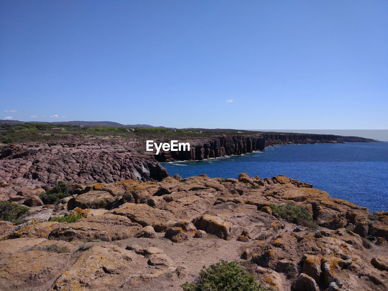 Scenic view of sea against clear blue sky