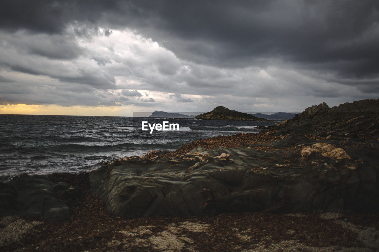 SCENIC VIEW OF SEA AND LANDSCAPE AGAINST SKY