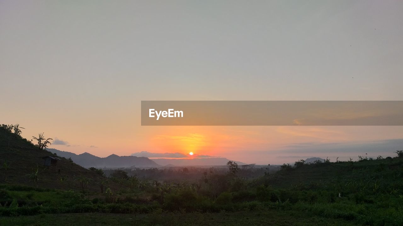 Scenic view of landscape against sky during sunset