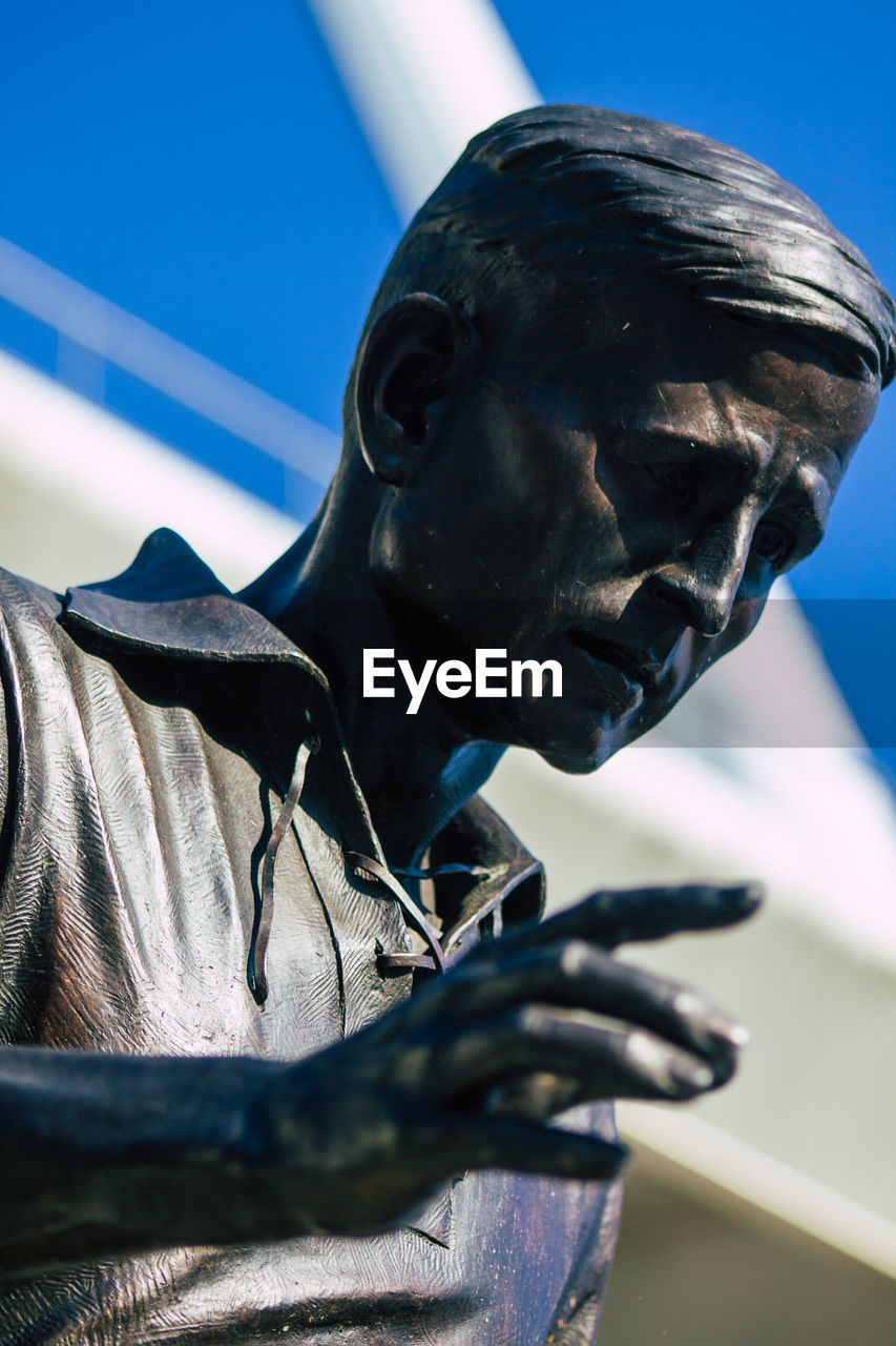 CLOSE-UP OF STATUE AGAINST CLEAR SKY