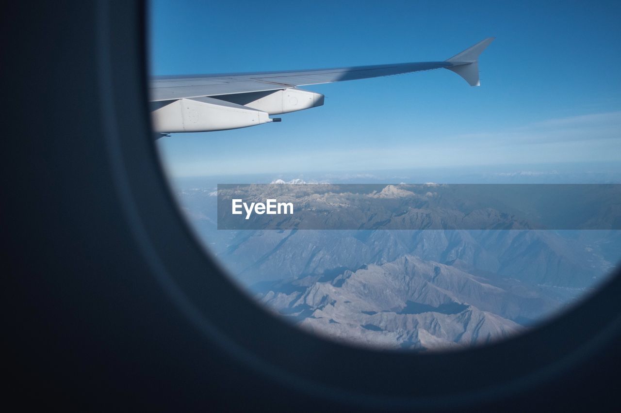 Aerial view of mountains seen through airplane window