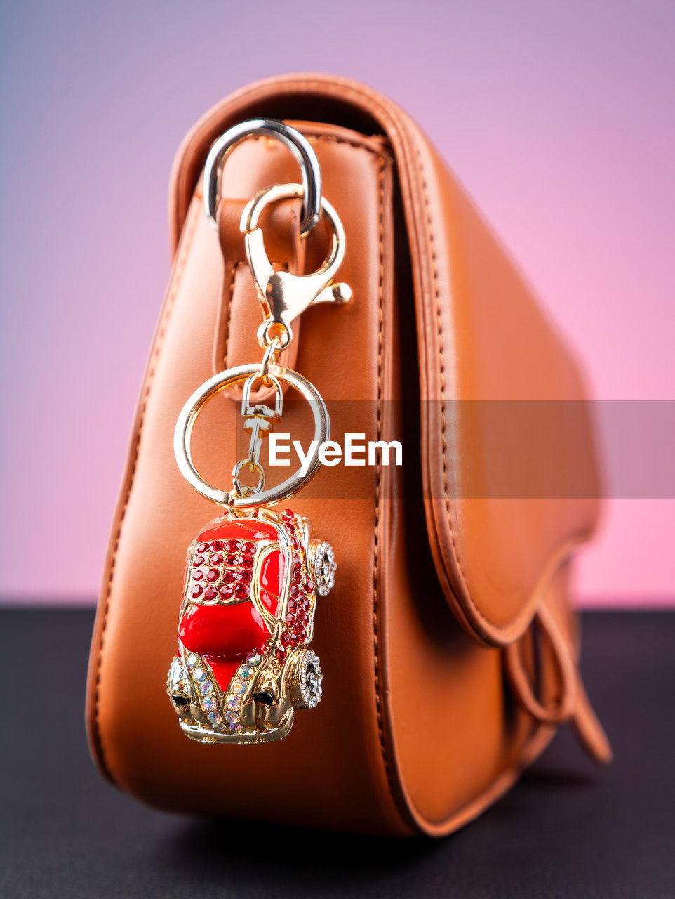 fashion accessory, studio shot, jewelry, colored background, pink, no people, orange, indoors, gold, brown, wealth, handbag, close-up, single object, fashion, necklace, luxury