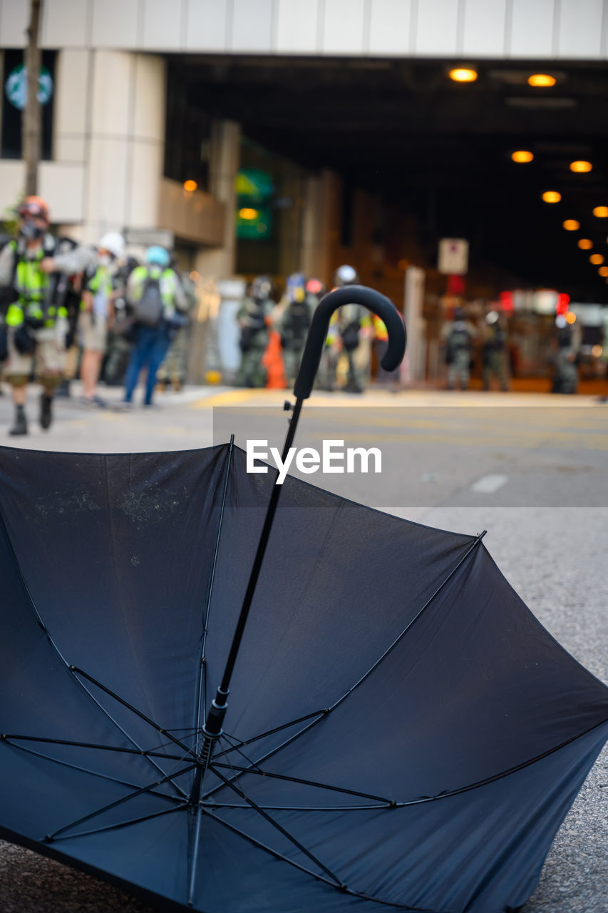 Close-up of wet umbrella on street in rainy season