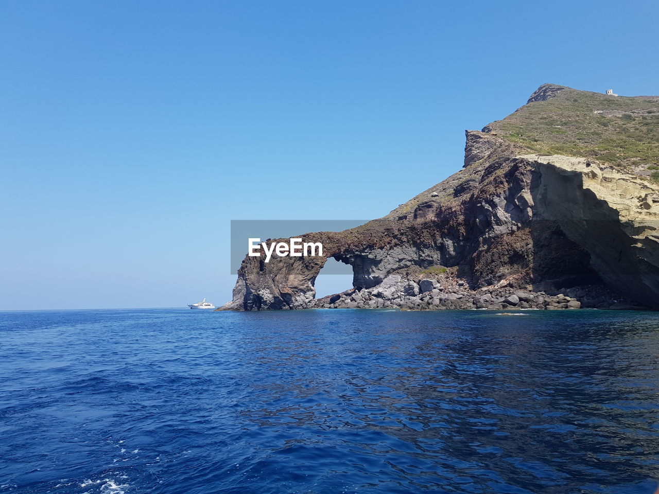 Scenic view of sea against clear blue sky