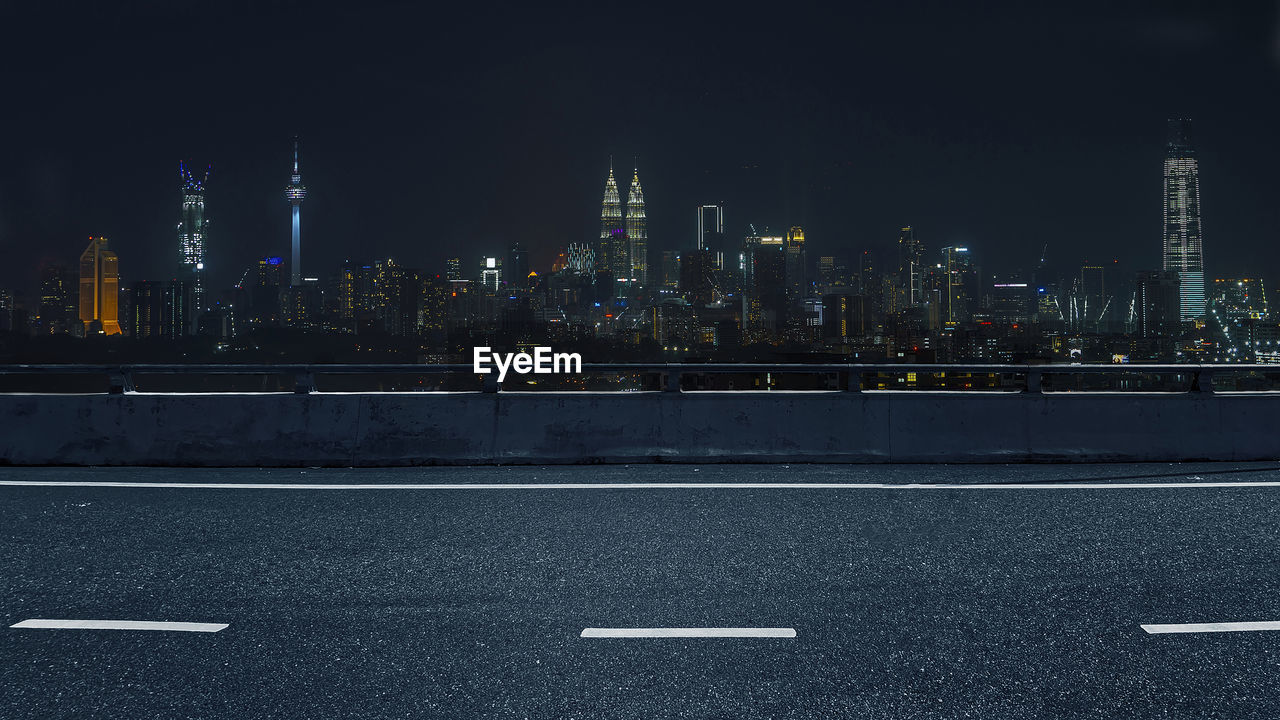 Empty road or highway with a view of city night background scene.