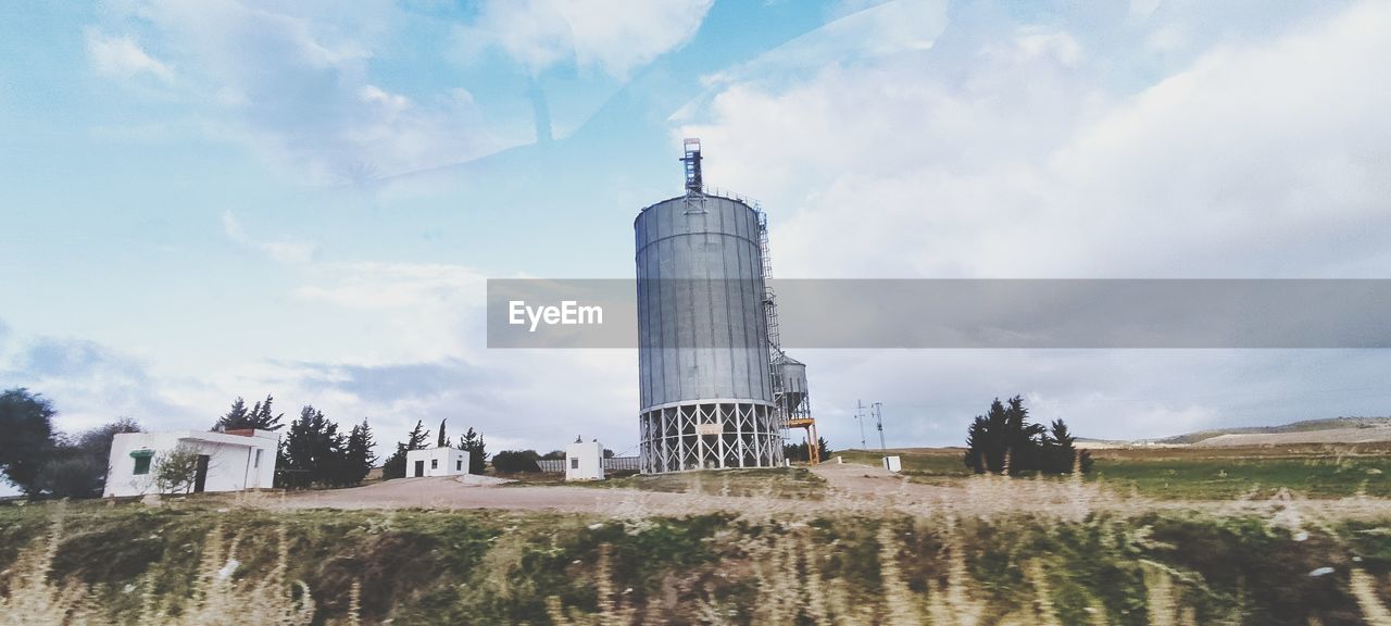 tower, architecture, built structure, sky, cloud, building exterior, landmark, nature, building, landscape, lighthouse, travel destinations, plant, day, environment, no people, travel, outdoors, history, the past, tree, land, rural area, tourism, water, industry, city, scenics - nature