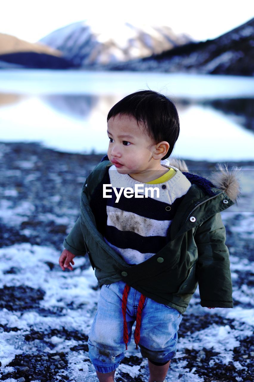 Portrait of boy standing at a lake