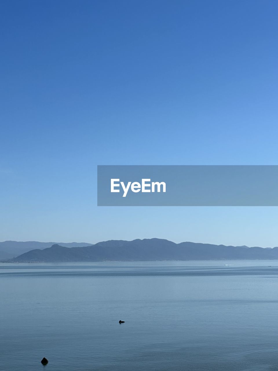 water, sky, horizon, scenics - nature, mountain, blue, beauty in nature, tranquility, sea, tranquil scene, body of water, nature, clear sky, ocean, copy space, day, no people, mountain range, bay, shore, non-urban scene, land, outdoors, landscape, environment, animal themes, animal, travel destinations, coast, idyllic, travel, bird, animal wildlife, beach, sunny, reflection, cloud, distant, remote, wildlife