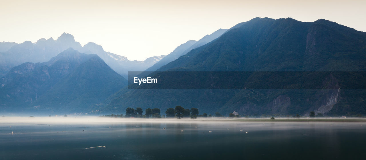 Scenic view of lake and mountains against sky