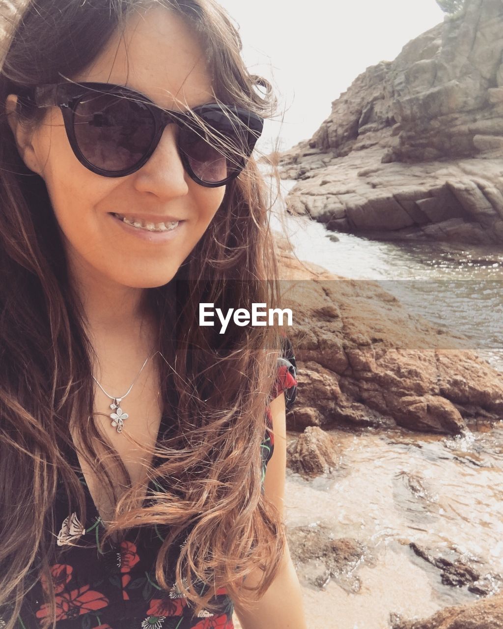 Portrait of young woman on sea shore