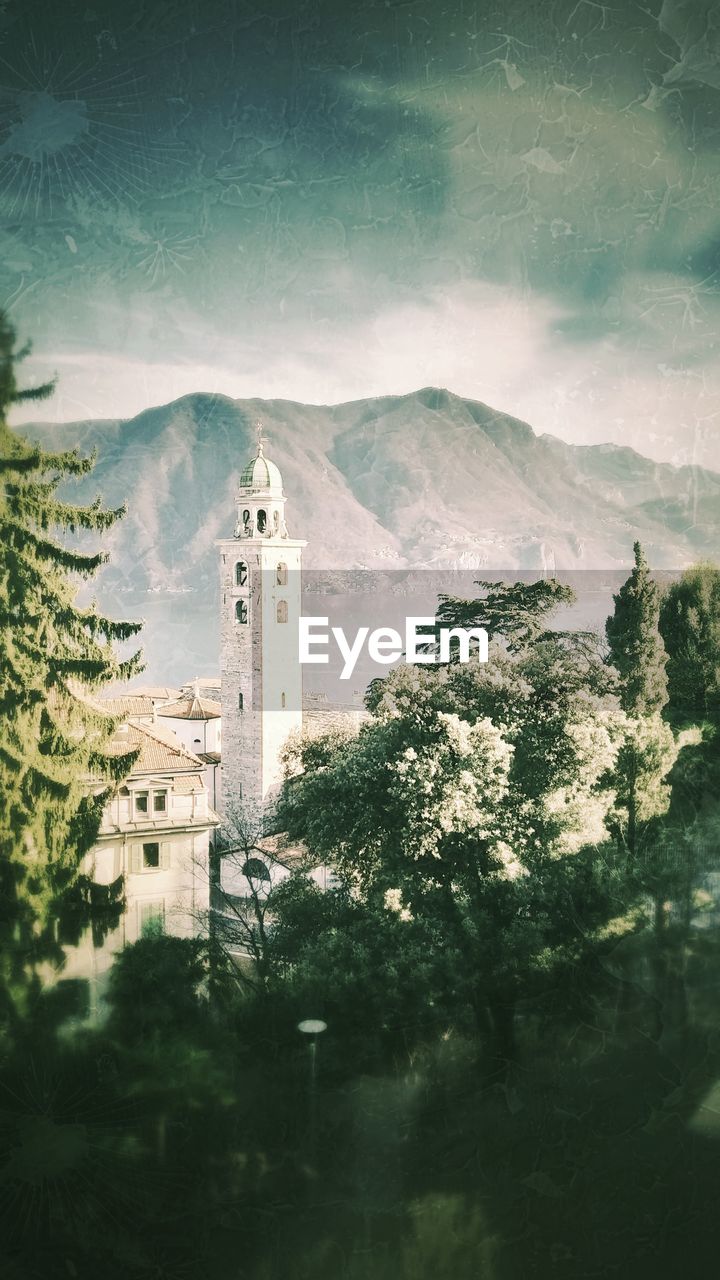 Trees and a church tower against sky in lugano switzerland 