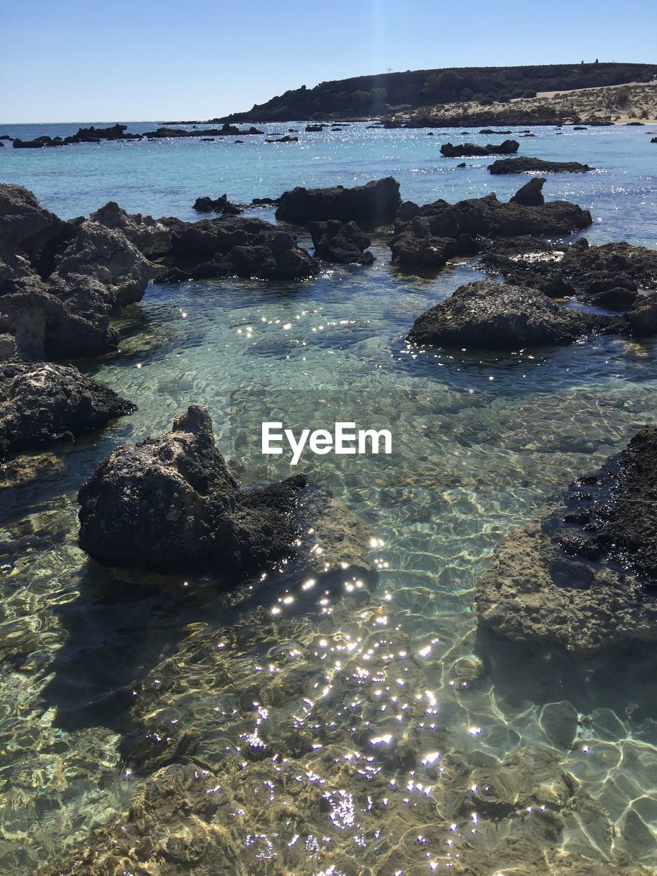 ROCKS ON SHORE AGAINST SKY