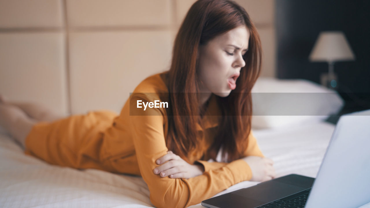 young woman using laptop on table