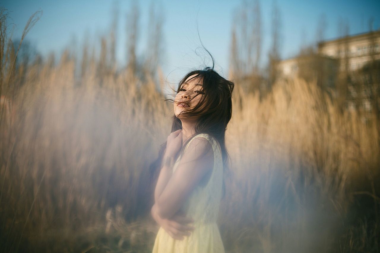 WOMAN STANDING ON FIELD