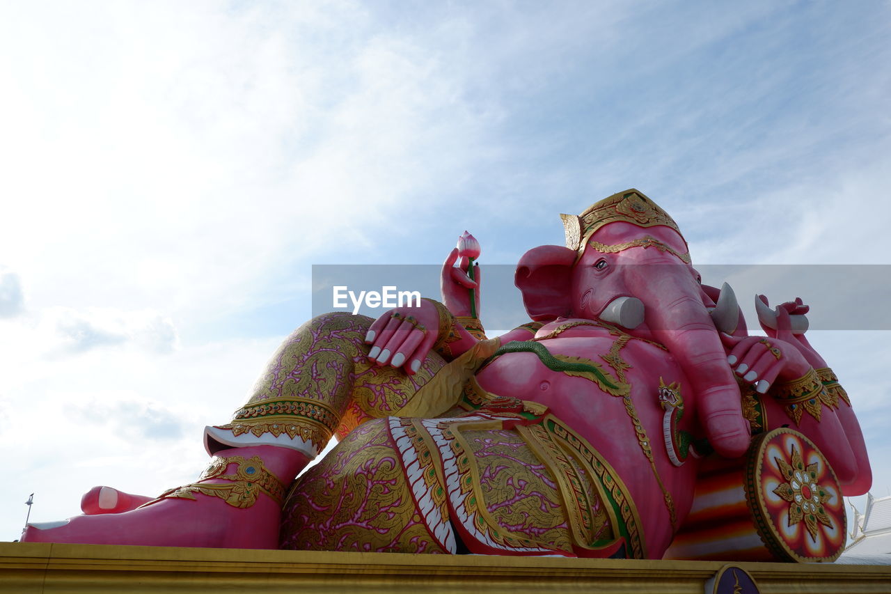 LOW ANGLE VIEW OF STATUE OF BUDDHA AGAINST SKY