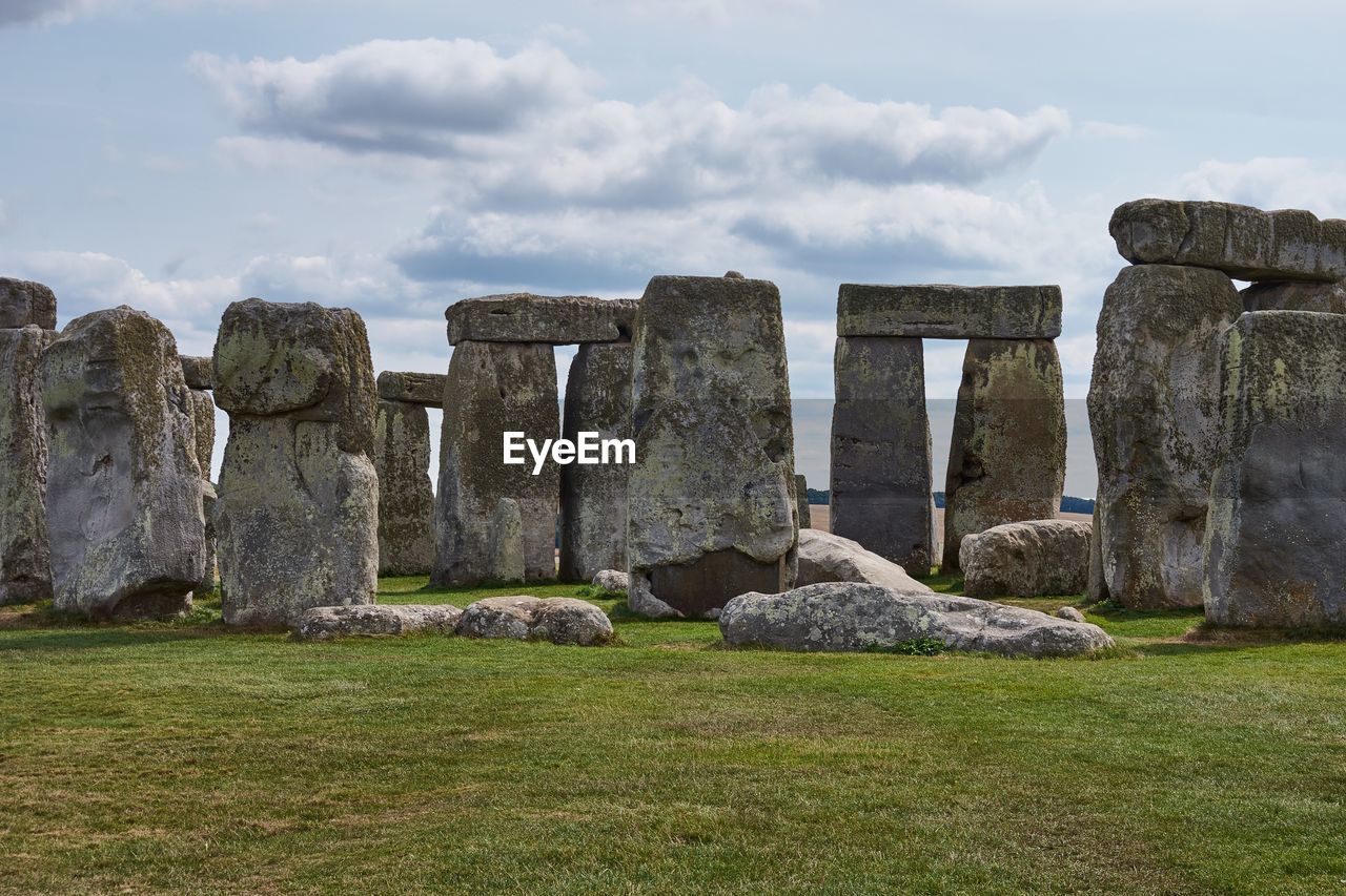 Neolithic stone circle on field against sky