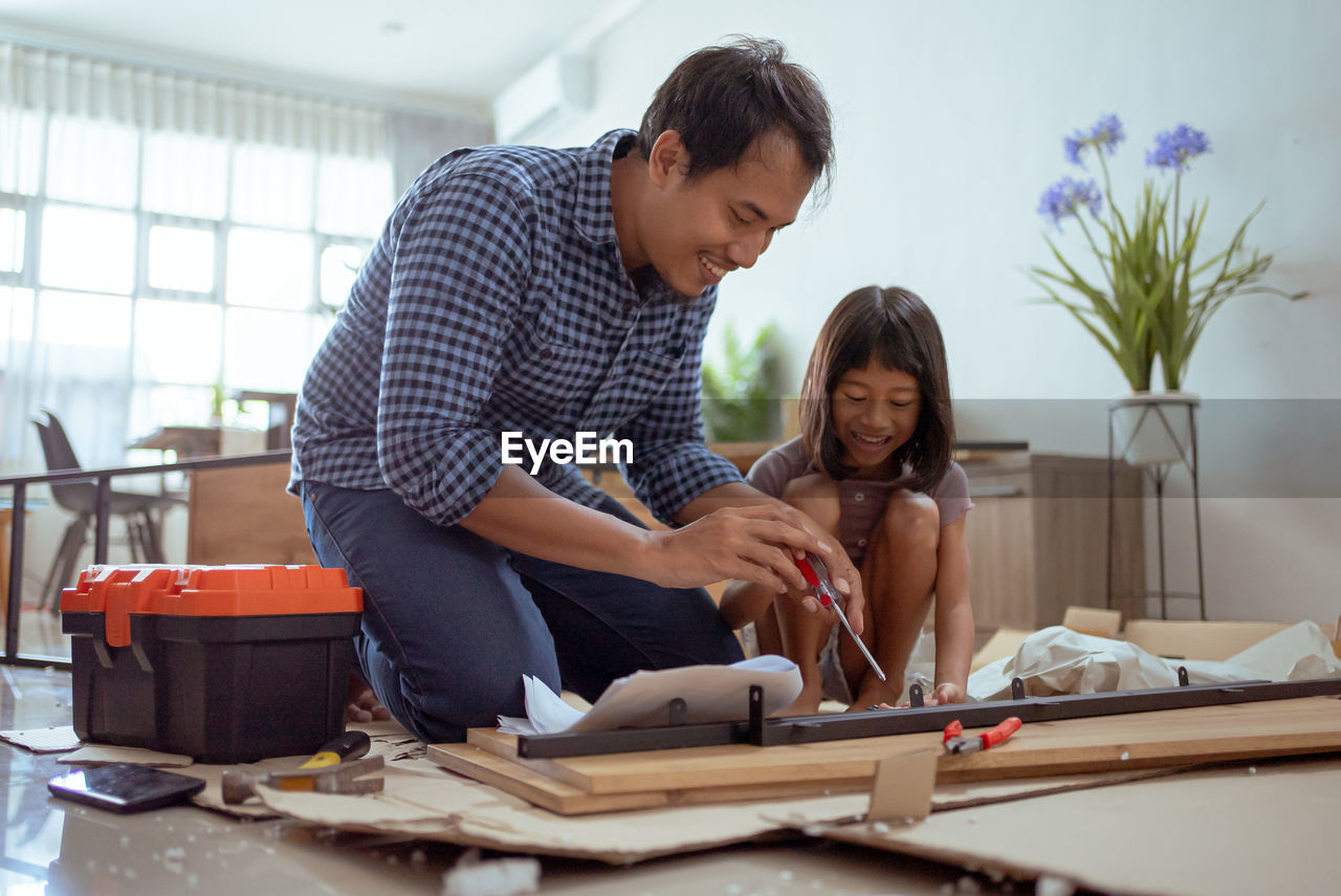 side view of man working on table