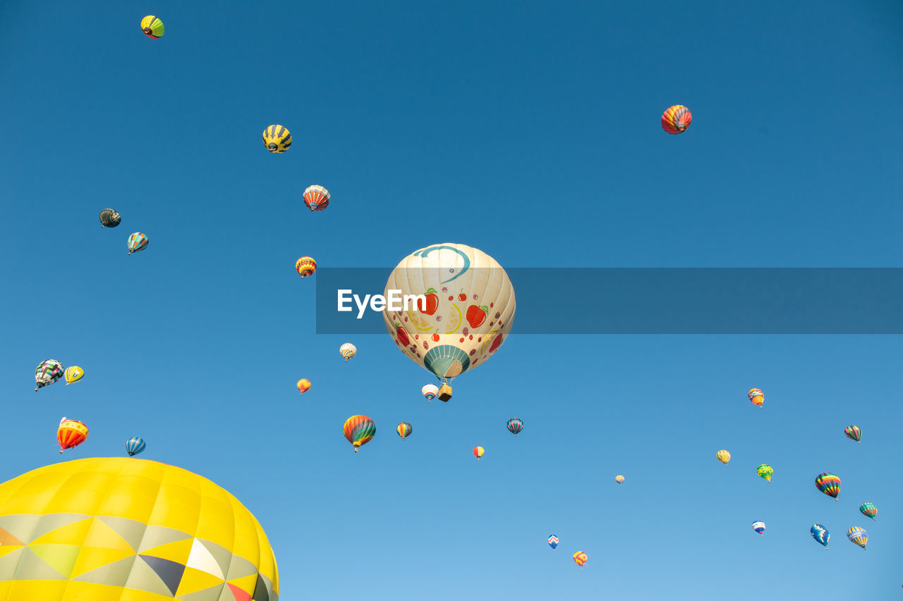 LOW ANGLE VIEW OF BALLOONS IN SKY