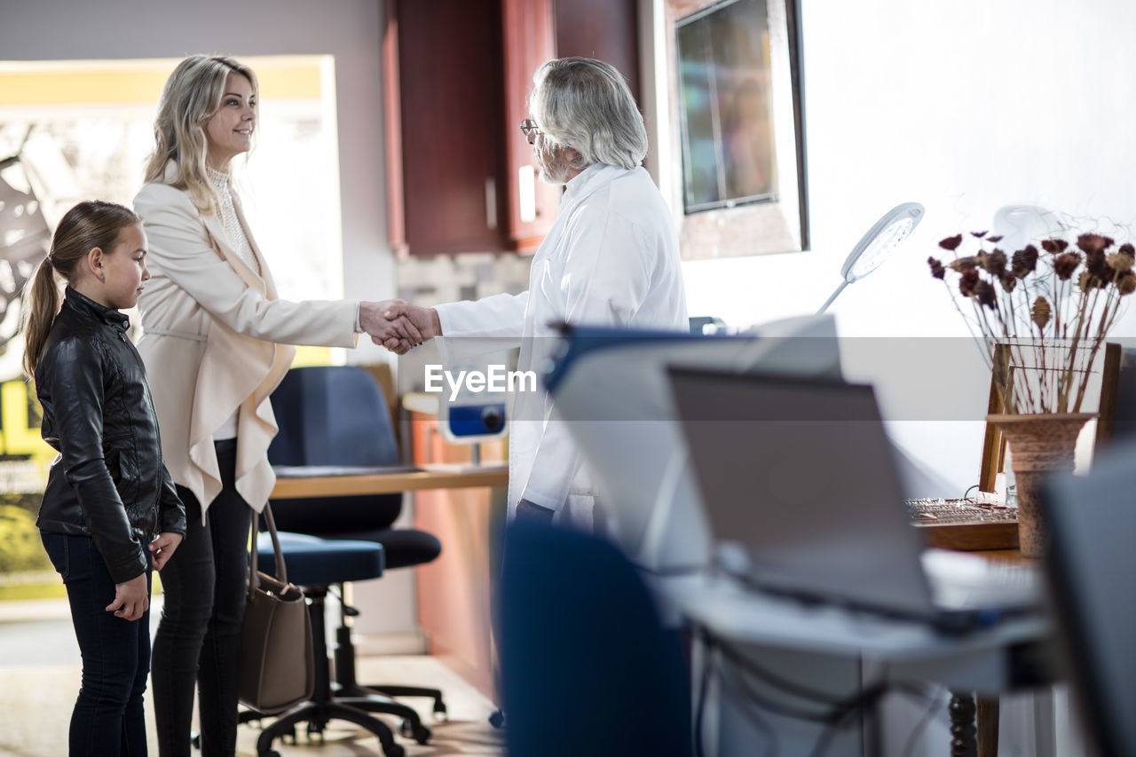 Doctor greeting patients in medical practice