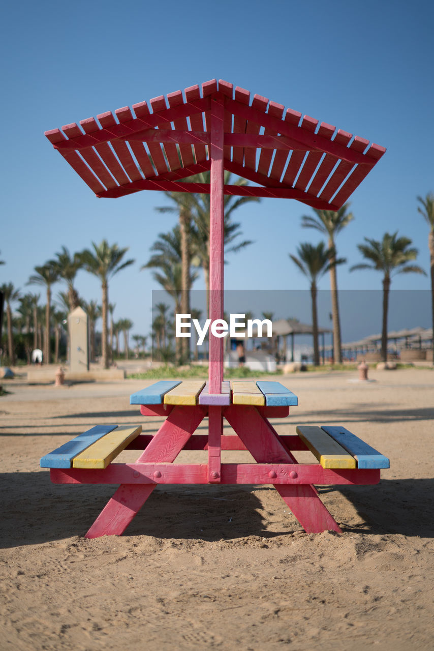 TRADITIONAL WINDMILL ON BEACH AGAINST SKY