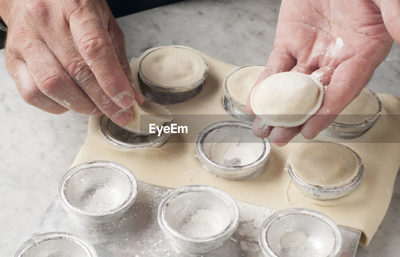 Cropped hands of chef preparing food on table in commercial kitchen